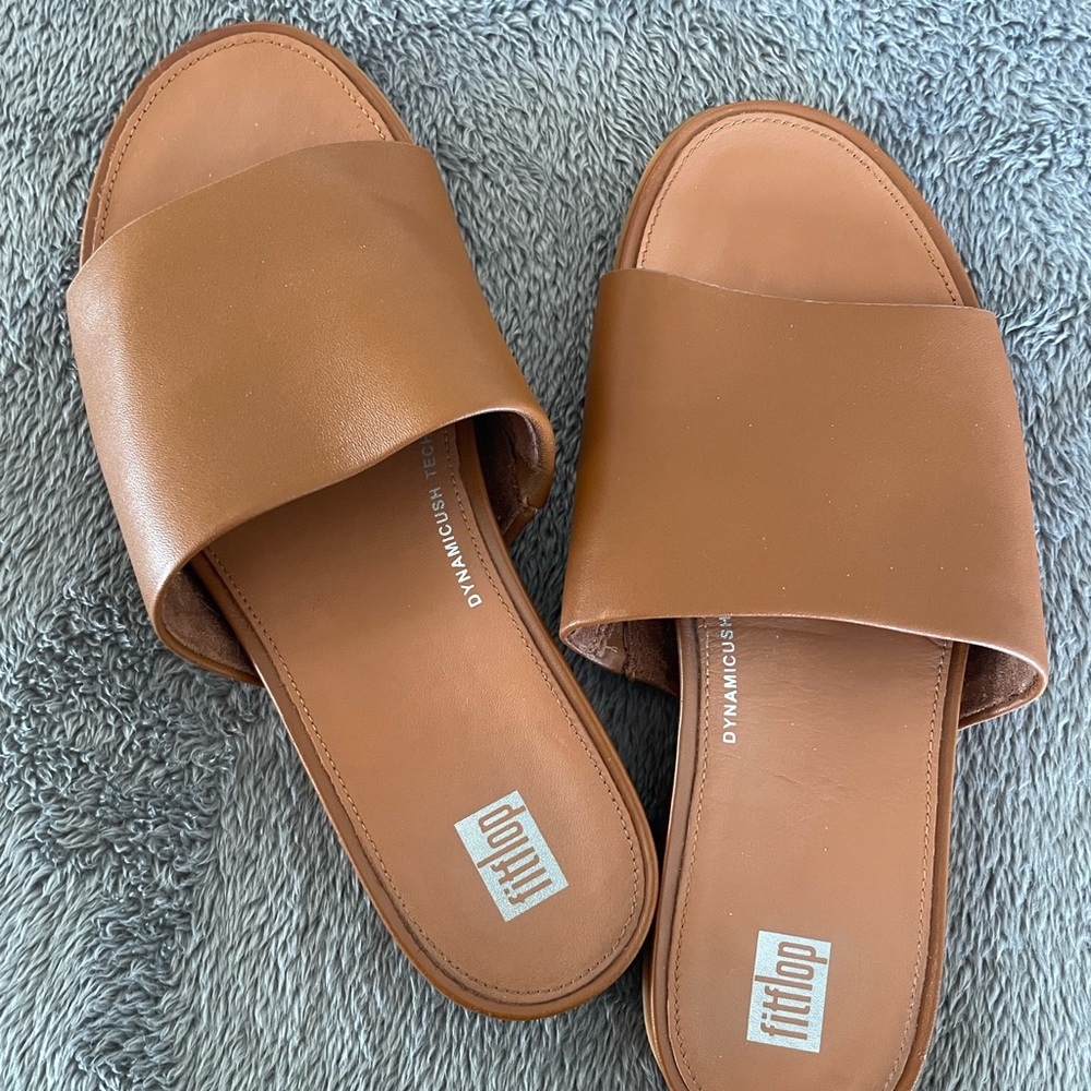 Tan FitFlop sandals.